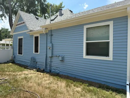 Light blue sided house with white trim, side view, Elements Painting project on the Colorado Front Range