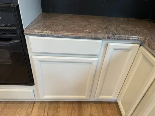 Light gray cabinet base under granite countertop, Elements Painting project on the Colorado Front Range