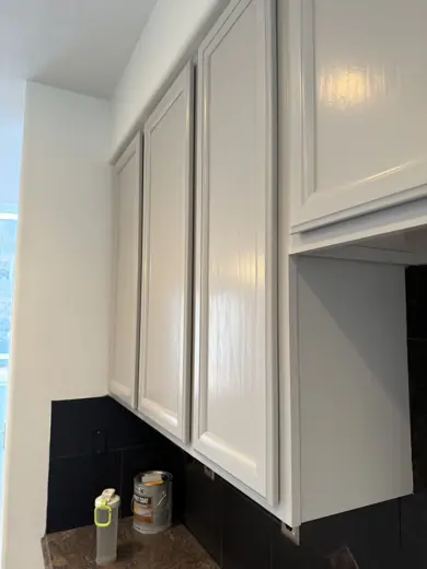 Light gray cabinet corner detail with black backsplash, Elements Painting project on the Colorado Front Range