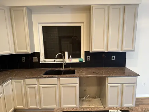 Light gray cabinets under window with black backsplash, Elements Painting project on the Colorado Front Range