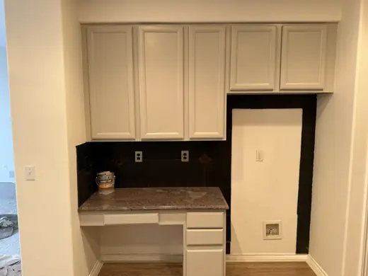 Light gray cabinets with black backsplash and granite counter, Elements Painting project on the Colorado Front Range