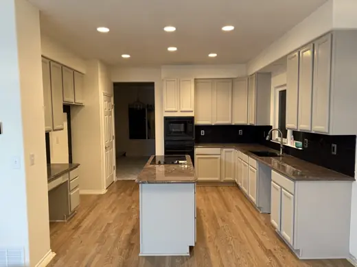 Light gray kitchen cabinets with white island, wood floors, Elements Painting project on the Colorado Front Range