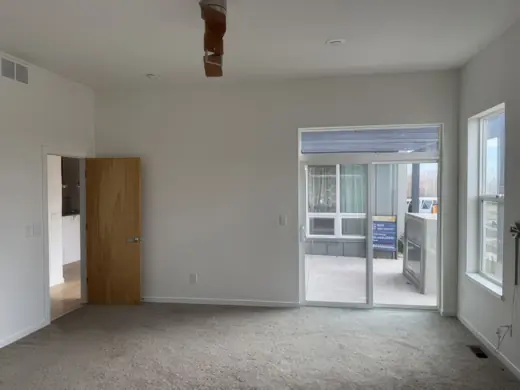 Living room with white walls, sliding door and carpet, Elements Painting project on the Colorado Front Range
