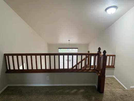 Loft with wood railing, vaulted ceiling and neutral paint, Elements Painting project on the Colorado Front Range