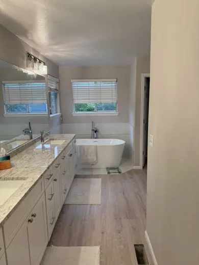 Long bathroom with white cabinets and light wood-look floors, Elements Painting project on the Colorado Front Range