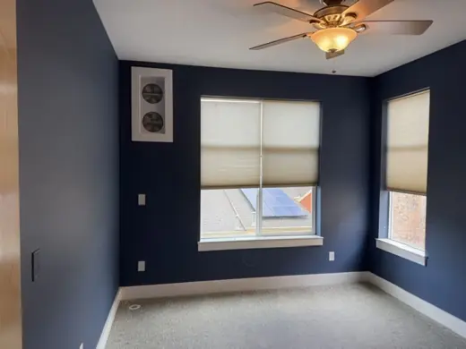 Navy blue bedroom walls, white trim, carpet, ceiling fan, Elements Painting project on the Colorado Front Range