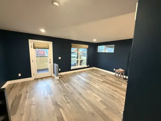 Navy blue living room walls, light gray wood flooring, Elements Painting project on the Colorado Front Range