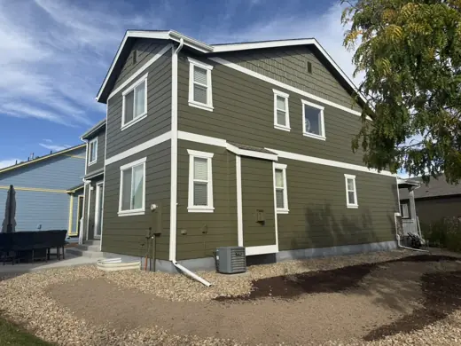 Olive green two-story home with tan trim, gravel, Elements Painting project on the Colorado Front Range