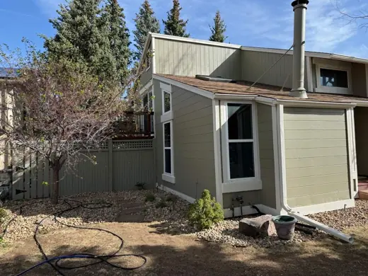 Sage green home with cream trim, rear yard and deck, Elements Painting project on the Colorado Front Range