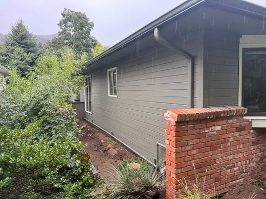 Sage green ranch home with brick wall, garden, Elements Painting project on the Colorado Front Range