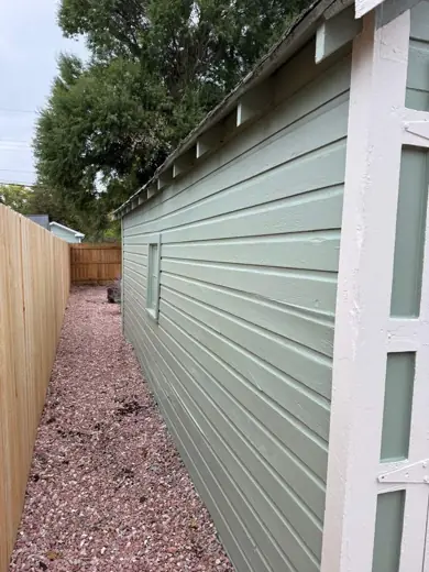 Sage green shed siding with fresh white trim corner, Elements Painting project on the Colorado Front Range
