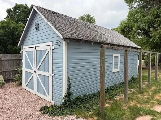 Sage green shed with white barn doors, fresh paint, Elements Painting project on the Colorado Front Range