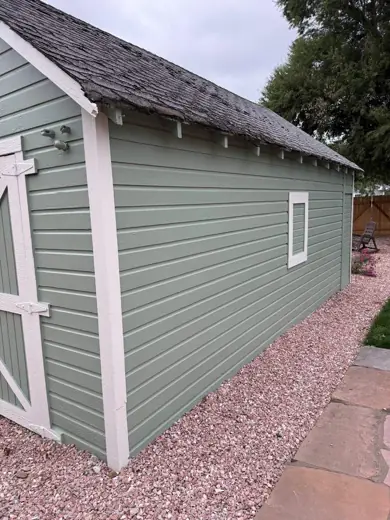 Sage green shed with white trim on gravel, Elements Painting project on the Colorado Front Range