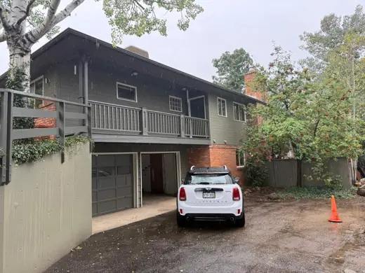 Sage green two-story home with carport and deck, Elements Painting project on the Colorado Front Range