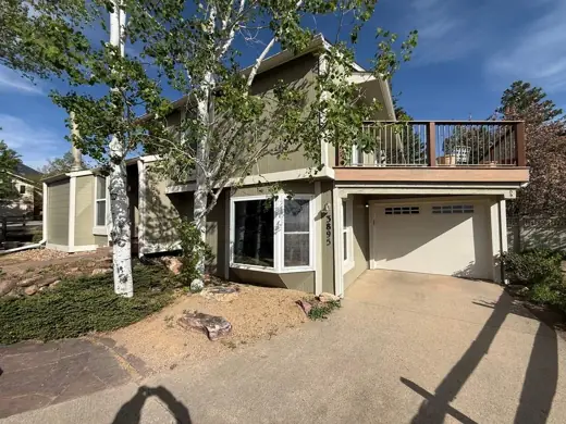 Sage green two-story home with cream trim, driveway and aspens, Elements Painting project on the Colorado Front Range