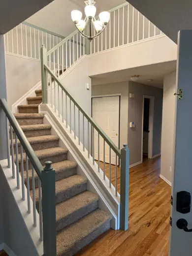 Staircase with white spindles and wood treads, freshly painted walls, Elements Painting project on the Colorado Front Range