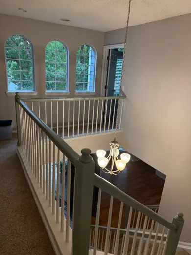 Stairwell with white and gray railing, arched windows, Elements Painting project on the Colorado Front Range