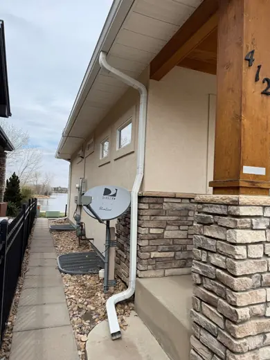 Stucco home entry with wood trim and stone base, Elements Painting project on the Colorado Front Range
