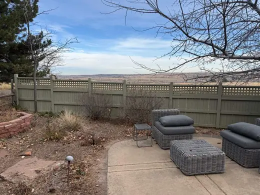Tan fence and patio with outdoor furniture, Elements Painting project on the Colorado Front Range