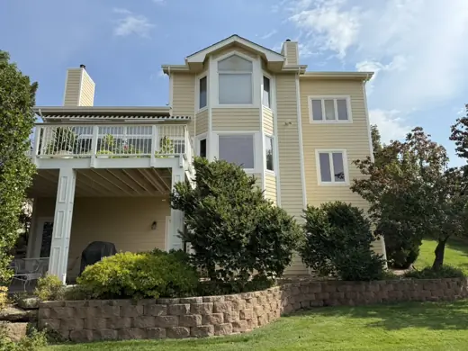 Tan multi-level home with balconies and stone wall, Elements Painting project on the Colorado Front Range