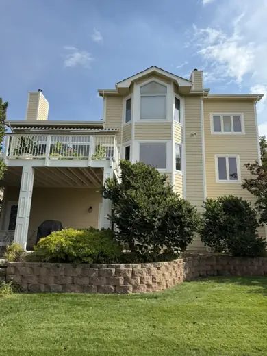Tan multi-story home with white balcony trim, Elements Painting project on the Colorado Front Range