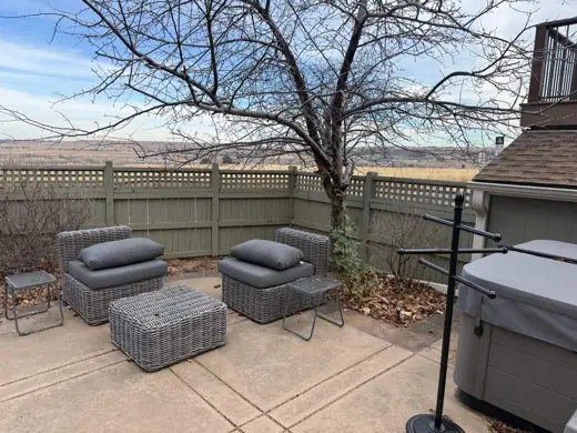 Tan painted fence around patio with gray seating, Elements Painting project on the Colorado Front Range