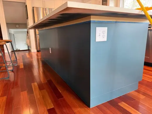 Teal blue painted island side, white top, wood floor, Elements Painting project on the Colorado Front Range
