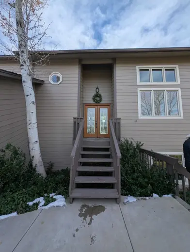 Two-story tan house with gray trim and wooden front steps, Elements Painting project on the Colorado Front Range