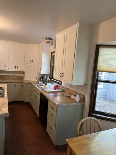 Two-tone kitchen corner with white uppers and sage lowers, Elements Painting project on the Colorado Front Range