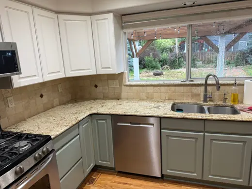 Two-tone kitchen: white uppers, gray-green lowers, granite counters, Elements Painting project on the Colorado Front Range