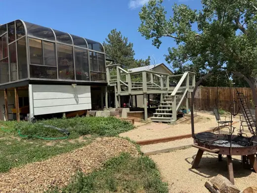 Weathered green home with sunroom before painting, Elements Painting project on the Colorado Front Range