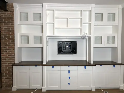 White built-in entertainment center against brick wall, Elements Painting project on the Colorado Front Range