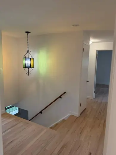 White hallway with pendant light and stairs, Elements Painting project on the Colorado Front Range