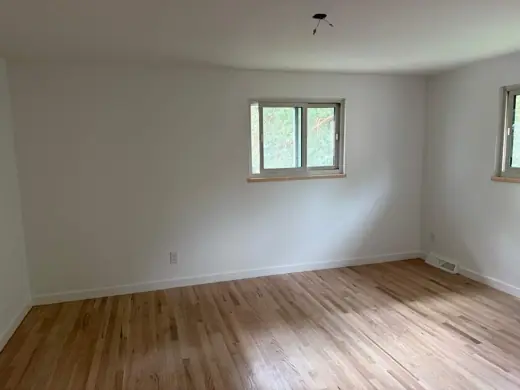 White living room with windows and light hardwood floor, Elements Painting project on the Colorado Front Range