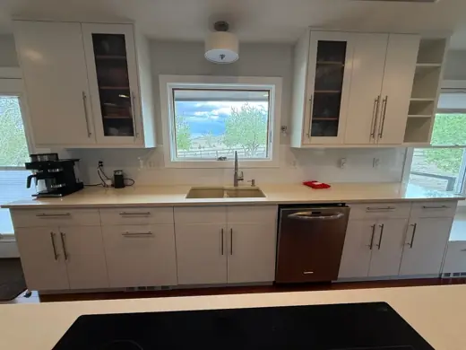 White modern kitchen cabinets with window and stainless dishwasher, Elements Painting project on the Colorado Front Range