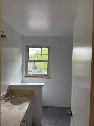 White painted bedroom with window and wood floor, Elements Painting project on the Colorado Front Range