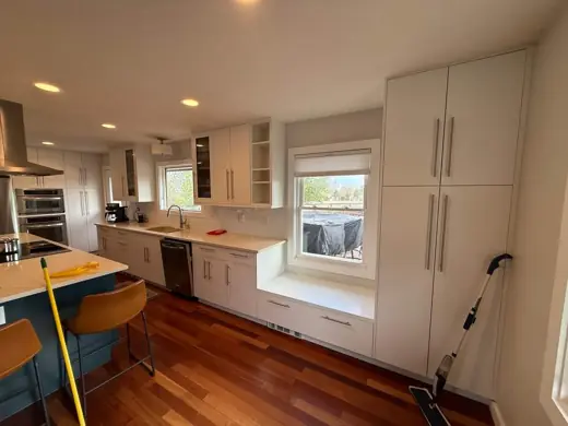 White painted cabinets and window, red-toned hardwood floor, Elements Painting project on the Colorado Front Range