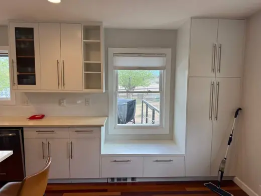 White painted kitchen cabinets around window, light countertop, Elements Painting project on the Colorado Front Range