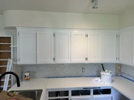 White painted shaker cabinets with marble backsplash, Elements Painting project on the Colorado Front Range