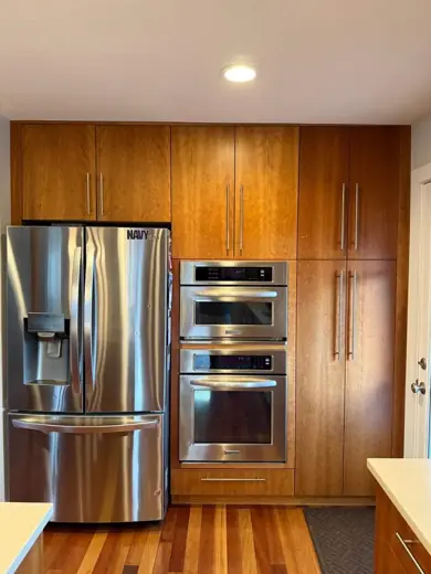 Wood cabinetry with stainless refrigerator and wall oven, Elements Painting project on the Colorado Front Range