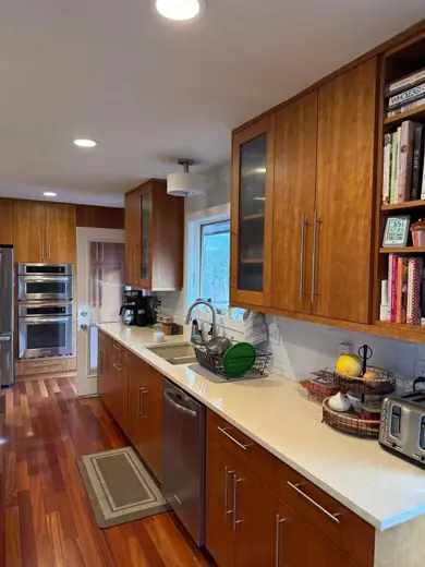 Wood tone cabinets along wall with white counter, Elements Painting project on the Colorado Front Range
